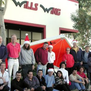 The Wills Wing Crew, 2001:
Back row, standing, l-r: Gene Atkins, Mike Meier, Mitch McAleer, Paul Diehl, Steven Pearson, Martha Diorio, Rick Zimbelman, Ken Howells, Martin Maldonado.
Front row, seated, l-r: Rob Kells, Carlos Mendosa, Carlos Lopez, Ruben Frausto, Gary Smith, Eva Hanska, Linda Meier, Victor Sosa, Peter Swanson (not pictured: Tom Blaty, Robert Robles).
