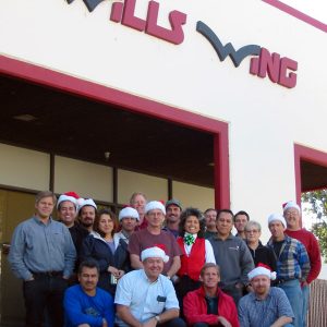 The Wills Wing Crew, 2002:
Back row, standing, l-r:Ken Howells, Ruben Frausto, Victor Sosa, Eva Hanska, Peter Swanson, Mike Meier, Gary Smith, Rich Collins, Linda Meier, Paul Diehl, Martin Maldonado, Tom Blaty, Martha Diorio, Steven Pearson, Rick Zimbelman.
Front row, seated, l-r: Carlos Mendosa, Chris Wills, Rob Kells, Gene Atkins, (not pictured: Mitch McAleer).
