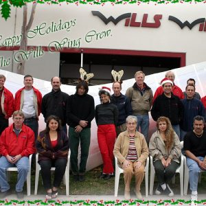 The Wills Wing Crew, 2003:
Back row, standing, l-r: Ken Howells, Paul Diehl, Rich Collins, Mitch McAleer, Linda Meier, Steven Pearson, Mike Meier, Ruben Frausto, Rick Zimbelman, Martin Maldonado, Tom Blaty, Victor Sosa, Rob Kells.
Front row, seated, l-r: Gene Atkins, Gary Smith, Eva Hanska, Martha Diorio, Narcisa Hartsch, Carlos Mendosa, Peter Swanson (not pictured: Chris Wills).
